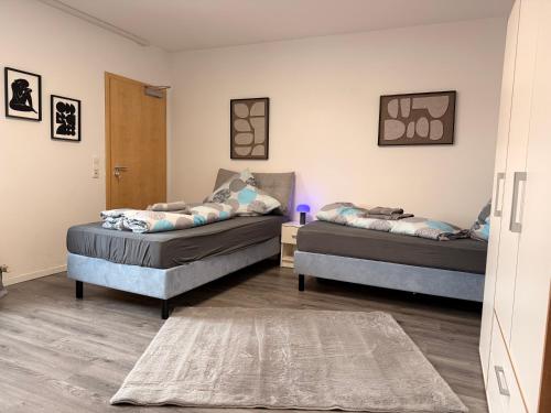 a room with two beds and a rug at Casa Daniela Residence in Vilshofen an der Donau