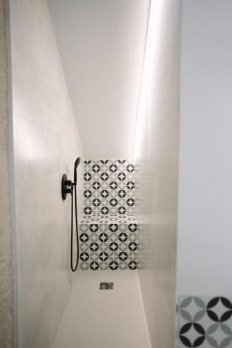 a shower in a bathroom with a metal door at Casa Deitania I in Caravaca de la Cruz