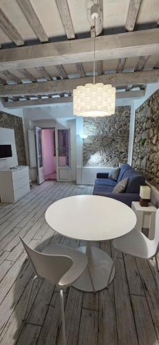 a living room with a white table and a couch at Blue Living-Borgo Antico in Marciana Marina