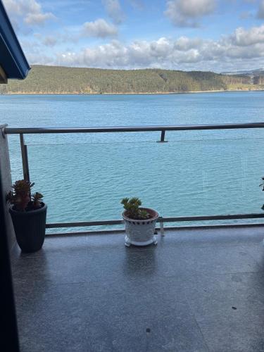 a balcony with a view of a large body of water at Area 3B in Camariñas