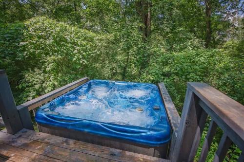 a hot tub sitting on a wooden deck at Eden Cabin Forested Tiny Home On Lookout Mtn in Chattanooga