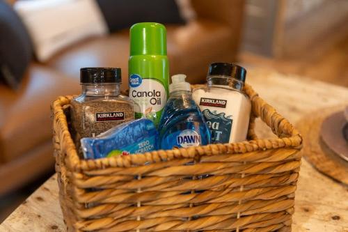 a basket with bottles of alcohol on a table at Eden Cabin Forested Tiny Home On Lookout Mtn in Chattanooga