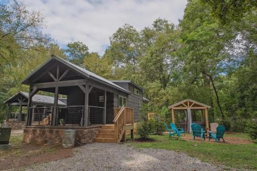 a cabin in the woods with a gazebo and chairs at Luke Cabin Escape To Our Luxury Hot Tub Cabin in Chattanooga