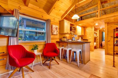 a kitchen with red chairs and a table in a cabin at Eliza Cabin Nature Nested Tiny Cabin W Hot Tub in Chattanooga