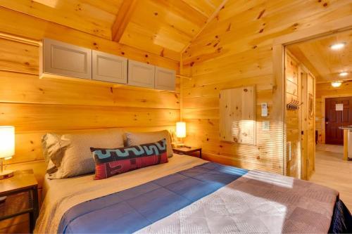 a bedroom with a bed in a log cabin at Eliza Cabin Nature Nested Tiny Cabin W Hot Tub in Chattanooga
