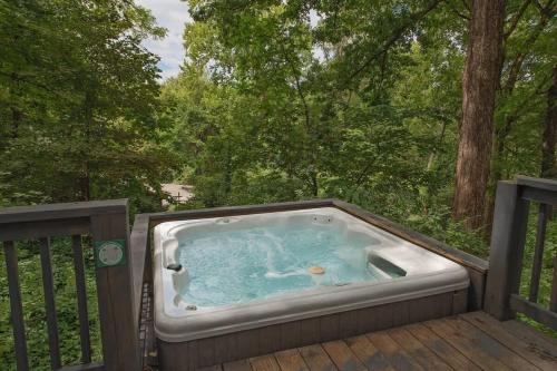 a hot tub on a deck with trees at Kai Cabin Wauhatchie Woodlands Close To Downtown in Chattanooga