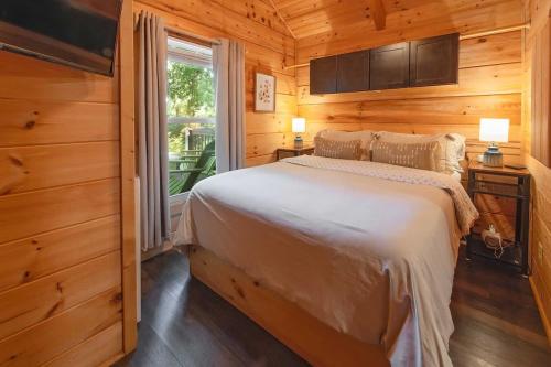 a bedroom with a bed and a large window at Kai Cabin Wauhatchie Woodlands Close To Downtown in Chattanooga