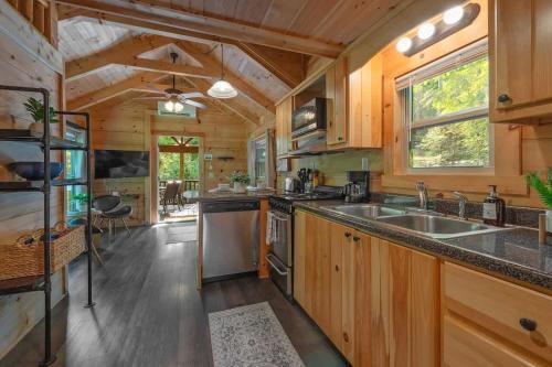 a kitchen with wooden cabinets and a large counter top at Kai Cabin Wauhatchie Woodlands Close To Downtown in Chattanooga