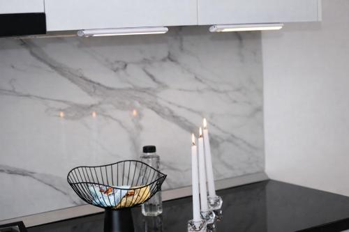 a kitchen with two candles and a counter with a counter top at White Pearl Residence in Roşu
