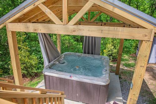 a hot tub in a wooden gazebo at Maggie Cabin Enjoy Nature From A Forest Hot Tub in Chattanooga