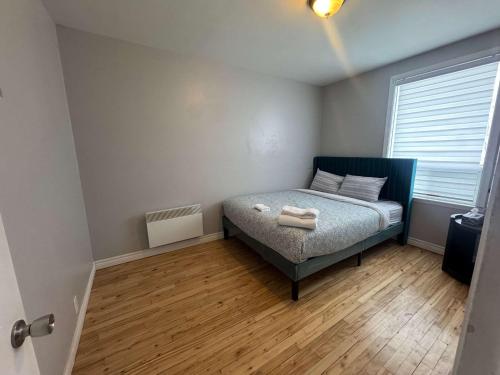 a small bedroom with a bed and a window at Condo ville de quebec in Quebec City