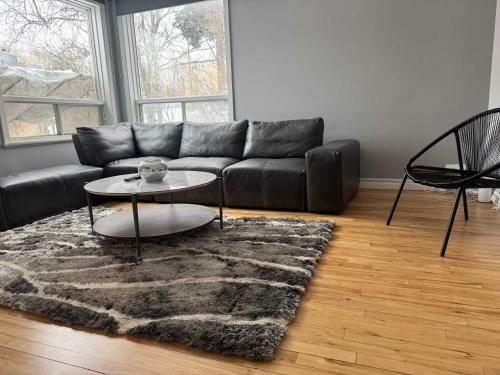 a living room with a couch and a table and a rug at Condo ville de quebec in Quebec City