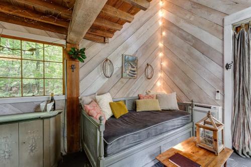 a room with a bench in the corner of a house at Treetop Hideaways: Luna Loft Treehouse in Flintstone