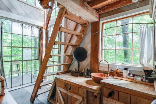 a kitchen with a wooden staircase in a tree house at Treetop Hideaways: Luna Loft Treehouse in Flintstone