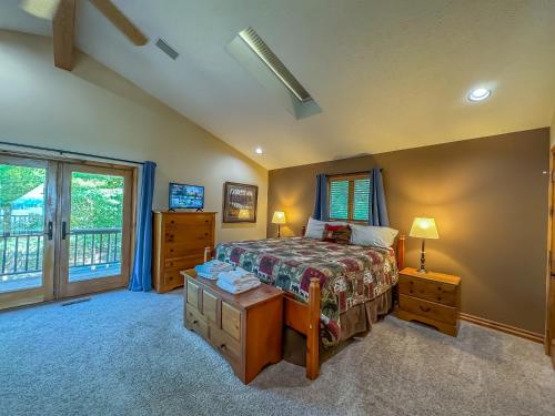a bedroom with a bed and a large window at New: Lake Access with Dock Slip More in Swanton