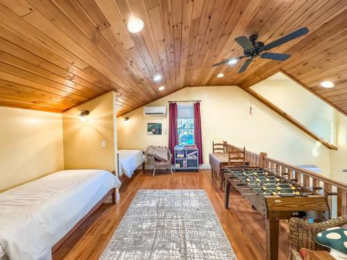 a room with two beds and a game table at New: Charming and Cozy Great Value in Swanton