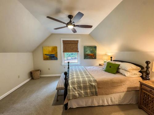 a bedroom with a bed with a ceiling fan at Modern Stunning Private Flat Lakefront in Oakland