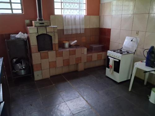 a kitchen with a stove and an oven in it at Sítio Limão Cravo in Areias