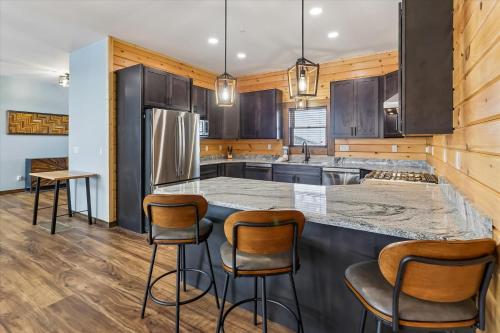 a kitchen with a large island with bar stools at Lakefront Private Indoor Pool New in Mountain Lake Park