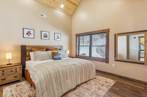 a bedroom with a bed and a dresser and a window at Lakefront Private Indoor Pool New in Mountain Lake Park