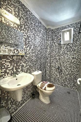 a bathroom with a toilet and a sink at Hedi Sozopol in Sozopol