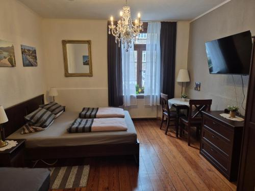 a bedroom with a bed and a dining room at Ehemaliges Winzerhaus Cochem in Cochem