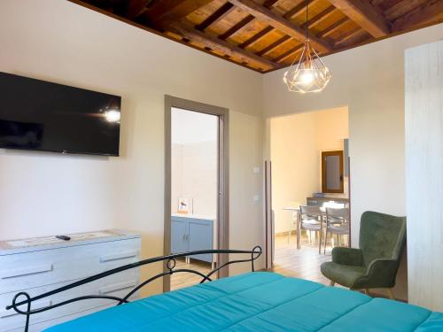 a bedroom with a bed and a dining room at Casale Saporito in Montopoli in Sabina