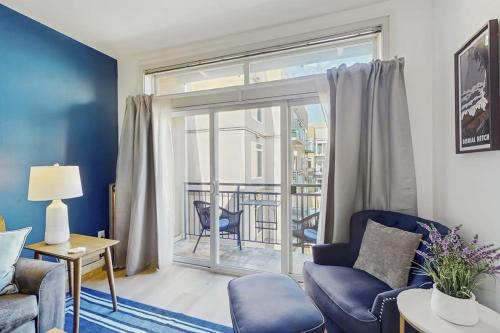 a living room with a couch and a sliding glass door at Sapphire of Belltown Court in Seattle
