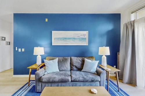 a living room with a couch and a blue wall at Sapphire of Belltown Court in Seattle