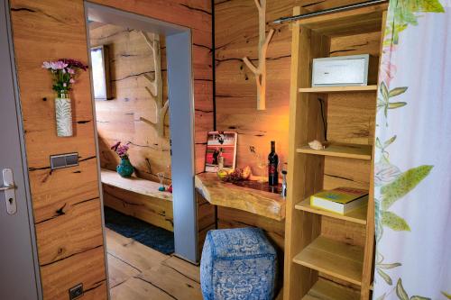 a room with a bathroom with wooden walls and a door at Pension Pulvermühle in Waischenfeld