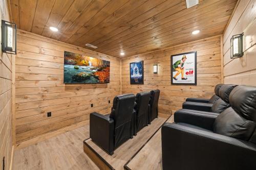 a cinema room with leather chairs and wooden walls at Indoor Pool Hot Tub, Pets Welcome, Arcade Games - Sleeps 14 in Pigeon Forge