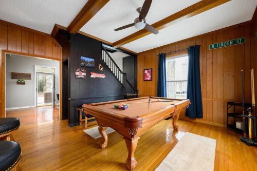 a pool table in a room with a ceiling fan at Elegant House 2 min from BSU/Hospital/Downtown in Muncie
