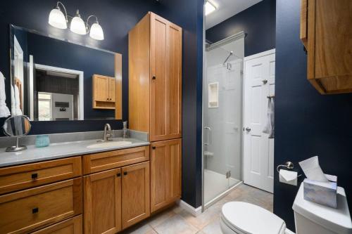 a bathroom with a toilet and a sink and a shower at Elegant House 2 min from BSU/Hospital/Downtown in Muncie