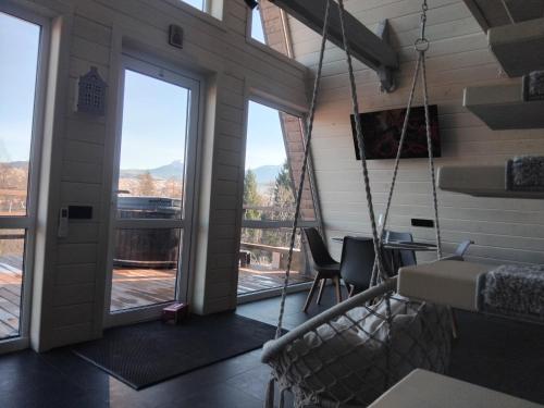 a room with a porch with a swing at A Frame HAPPINESS in Yasinya