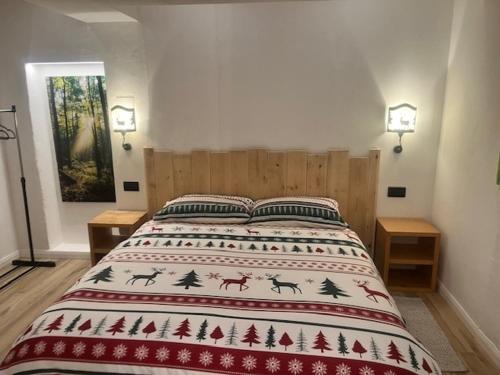 a bedroom with a bed with a christmas blanket on it at La Nicchia in Pieve di Cadore