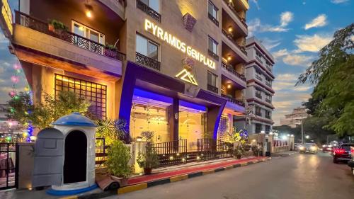 a building with a sign on the side of it at Pyramids Gem Plaza Hotel in Cairo