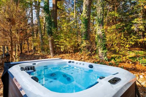 a jacuzzi tub in the woods at 1- Lookout Mountain Cottage in Lookout Mountain