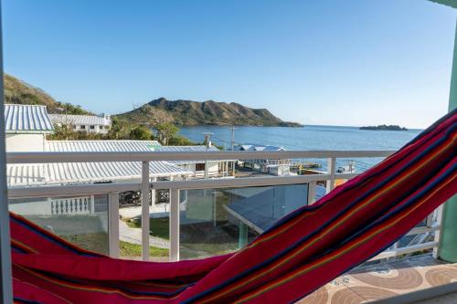 a hammock on a balcony overlooking the water at Posada Three Cay Suites in Providencia