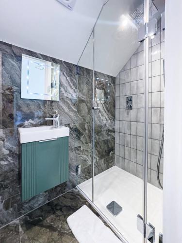 a bathroom with a shower and a sink at Luxury Seaside Home, Sleeps 6 in Broadstairs