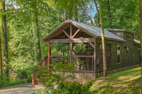 a cabin in the woods with a wrap around porch at Ryon Tiny Home Cabin City-side Rustic Retreat in Chattanooga