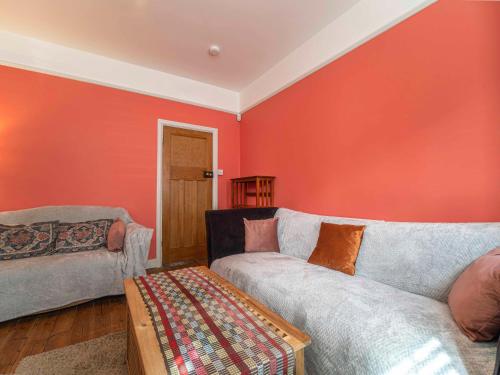 a living room with two couches and an orange wall at Margate Heritage House with Luxurious Beds, Garden, Pet Friendly , 3bd and 2 bath in Margate