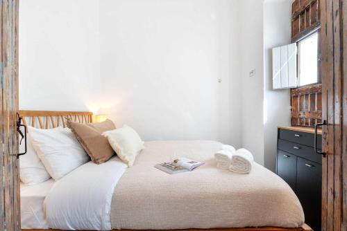 a bedroom with a bed with two towels on it at Spacious & Artistic House with Pool by HostWise in Moncarapacho