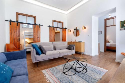 a living room with a couch and a table at Spacious & Artistic House with Pool by HostWise in Moncarapacho