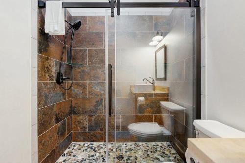 a bathroom with a shower with a toilet and a sink at Valley Vista Vacay 2 in Littleton