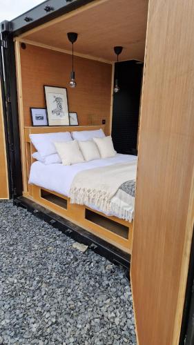 a bedroom with a bed inside of a room at Nyth - Nest Llangollen in Llangollen