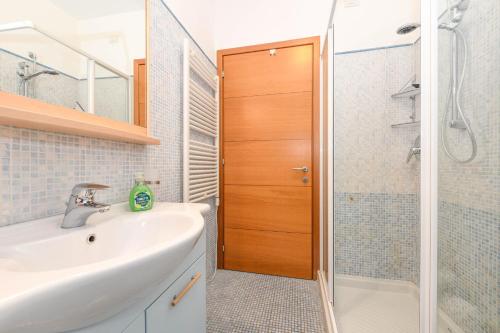 a bathroom with a sink and a shower at MGH- Lake Serenity Apartment in Padenghe sul Garda