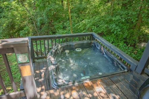 a hot tub on top of a deck at Sophie Cabin National Forest Tiny Cabin in Chattanooga