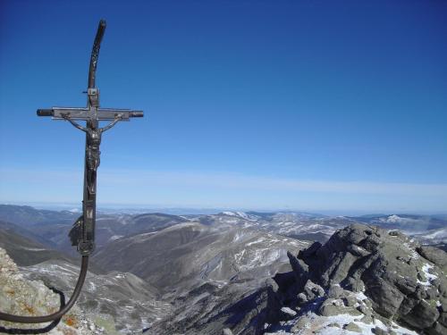 a cross hanging on the side of a mountain at C.T.R. Camino de la Fuentona in Cabrejas del Pinar
