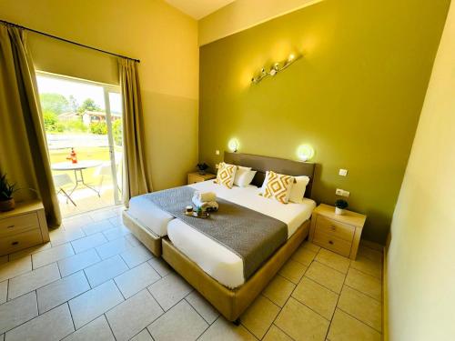 a bedroom with a large bed and a large window at Sidari Vibes Aparthotel in Sidari