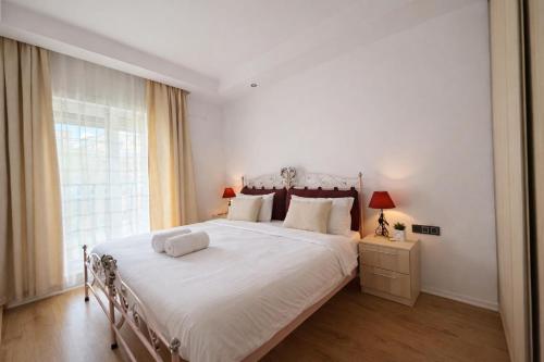 a bedroom with a large bed with white sheets and a window at Salvatore Apartment #BucharestAirport in Ştefăneştii de Sus